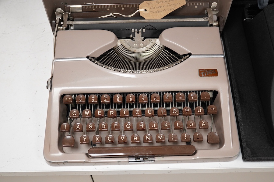 Three cased typewriters; a German Gossen Tippa, a Remington Travel-Riter and a German (U.S. Zone) Blue Bird. Condition - fair to good.